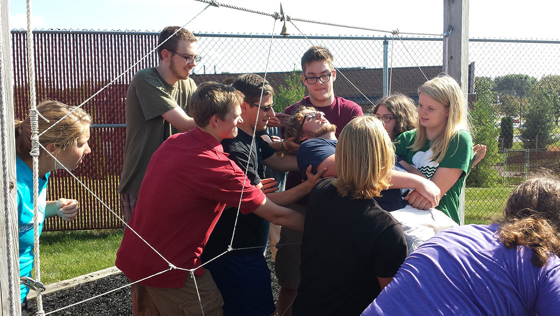 Teens work together on a Beyond Boundaries Challenge Course obstacle